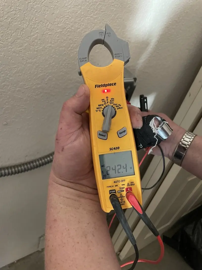 Voltage testing with clamp meter during Outlet Installation in Saddlebrooke